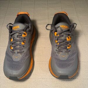 Hoka One One Men's Gray and Orange Running Shoes Stinson ATR 6 worn on couple x